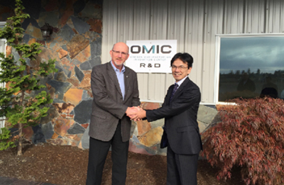 Shaking hands with the OMIC representative after signing